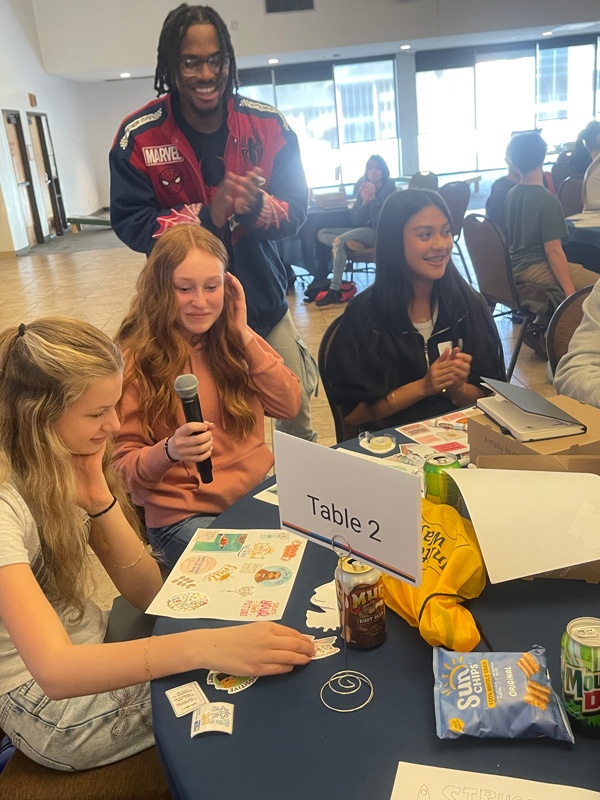 Several youth in a conference room at the YES Summit